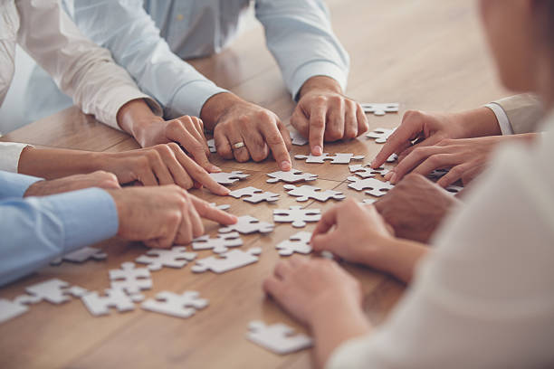 istock Business people putting together jigsaw puzzle 639198250