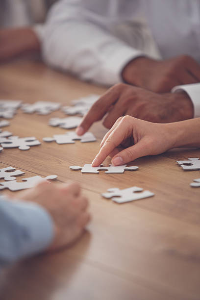 istock Business people putting together jigsaw puzzle 639198262