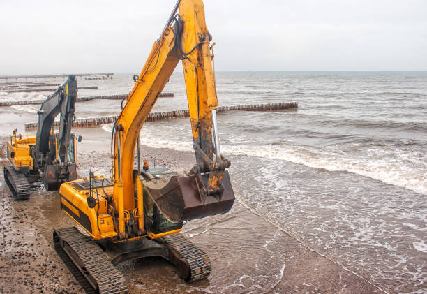 istock two excavators riding on the beach 639198392
