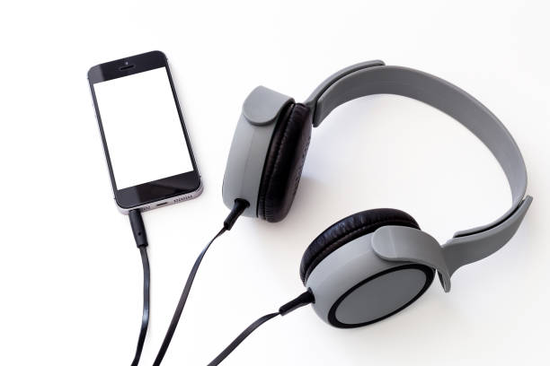 istock matte gray music headphone with smartphone connected isolated on 639198976
