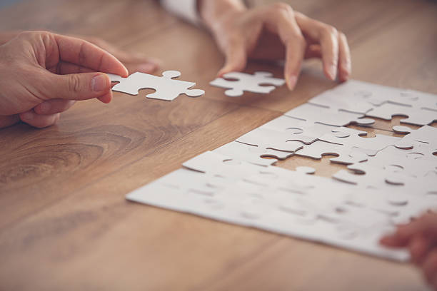 istock Business people putting together jigsaw puzzle 639200930