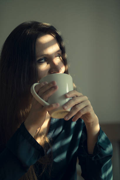 istock women at window striped light effect 639208016