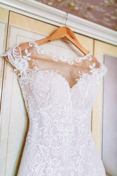 istock White Wedding dress on a shoulders, before ceremony 639211346