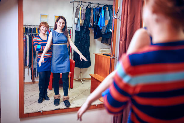 istock Young needlewoman taking measures of female client 639213212