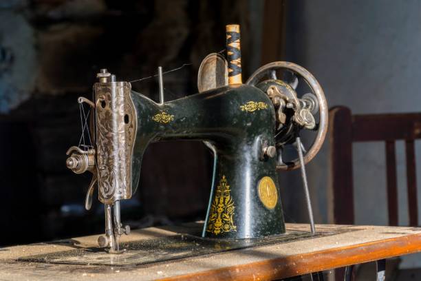 istock Forgotten black retro sewing machine in abandoned old house. 639219894