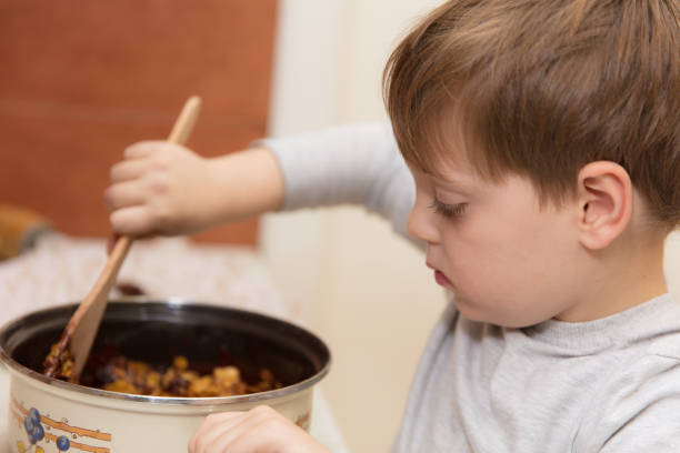 istock Little boy making cookies 639220470