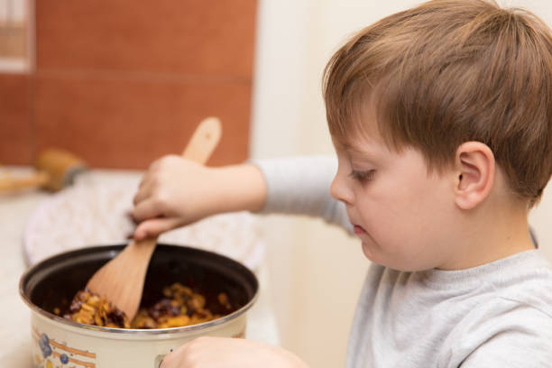 istock Little boy making cookies 639222118