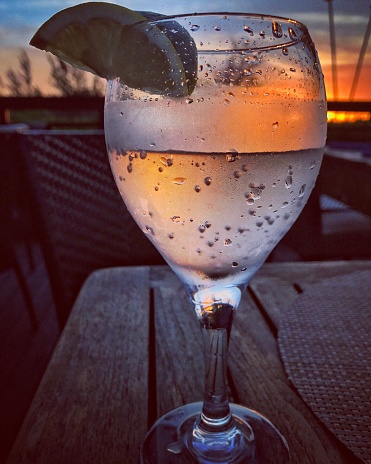 Sunset viewed through a Glass of sparkling water