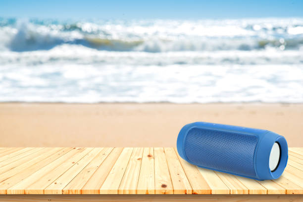 istock Smart phones and portable speaker on the beach. 639228400