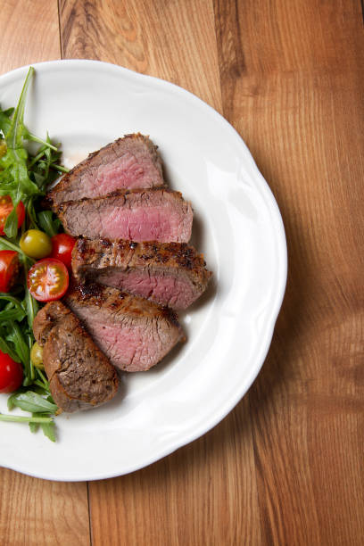 istock Grilled beef tenderloin with cherry tomatoes and arugula 639229454