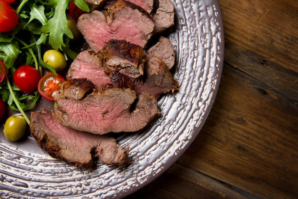 istock Grilled beef tenderloin with cherry tomatoes and arugula 639230972