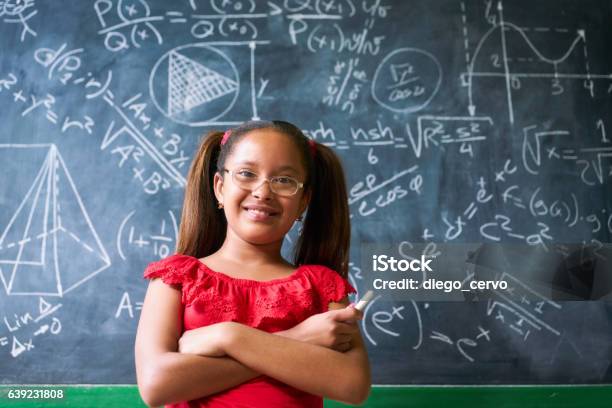 Portrait Happy Girl Resolving Complex Math Problem On Blackboard Stock Photo - Download Image Now