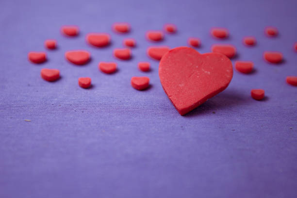 istock Red hearts on a purple background. Selective focus 639231992