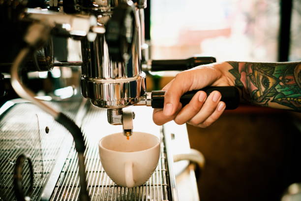 Baristas are coffee,by tattooed barista arm - fotografia de stock