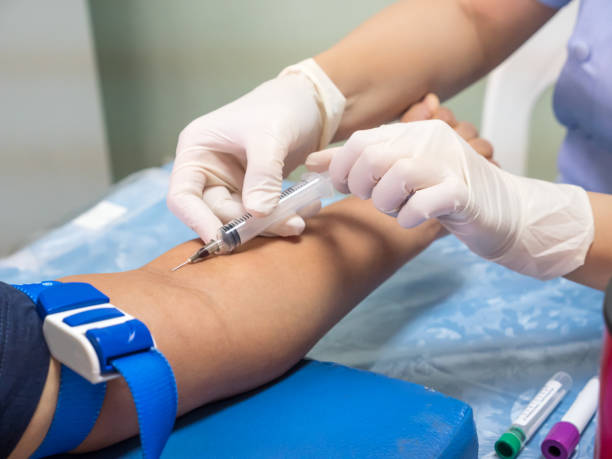 istock nurse with syringe is taking blood for test at the 639236368