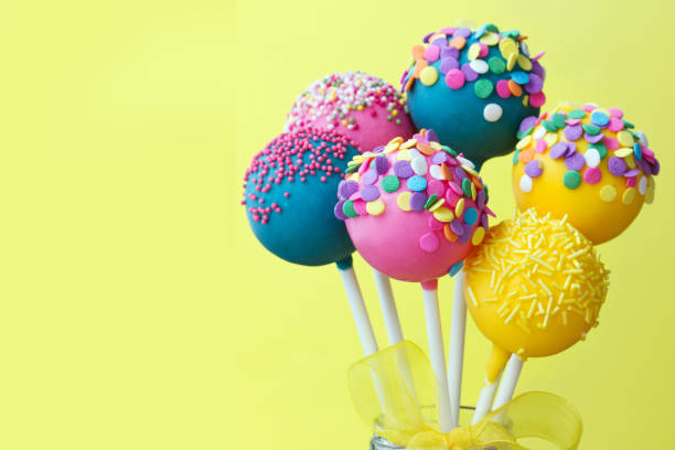 Colorful cake pops Colorful cake pops on a yellow background Cake Pop stock pictures, royalty-free photos & images