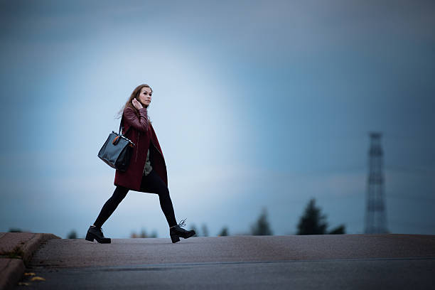 istock Woman walking home on dark bridge 639243512