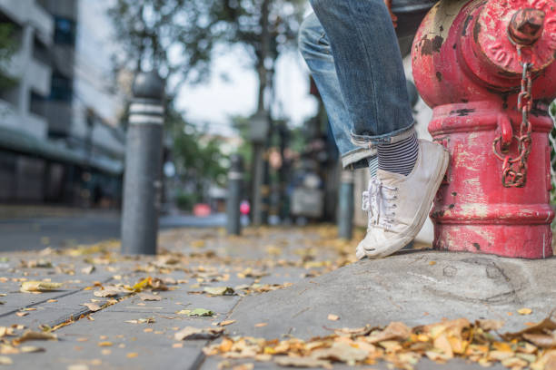 istock man legs wearing white shoes sitting 639244282