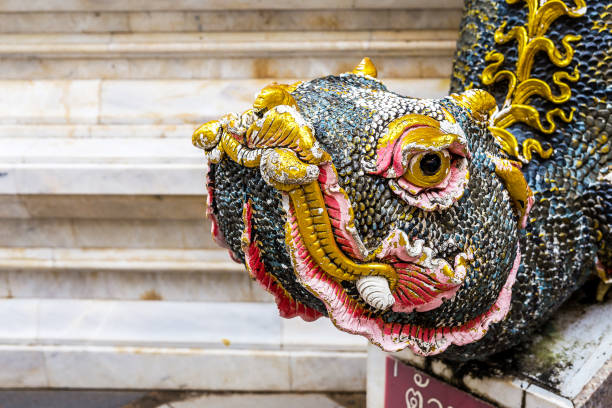 Buddhism dragon guard statue in sunlight, Thailand. Religion concept