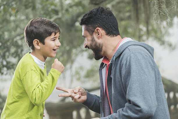 istock Hispanic father and son playing rock paper scissors 639245528