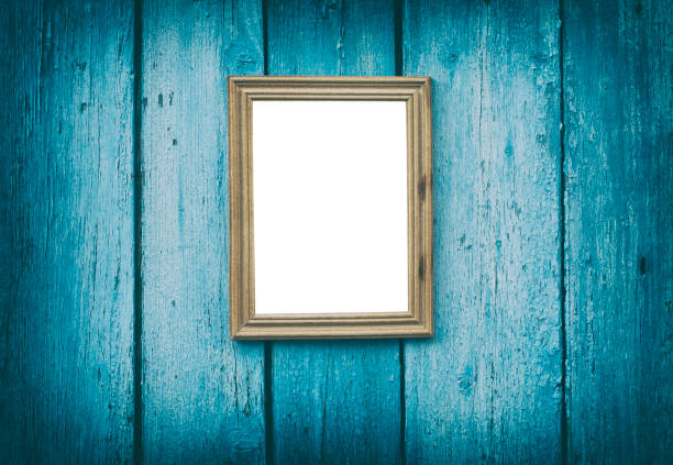 istock empty wooden frame hanging on blue cracked wooden wall 639248712