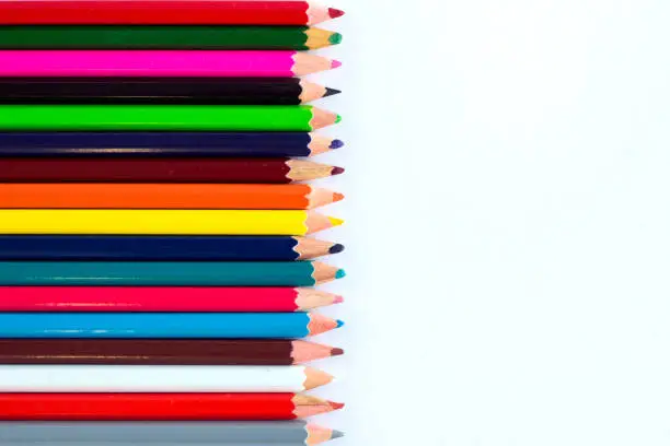 Photo of White background for presentation with vertical colourful border of pencils