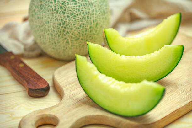 green melon Fresh sweet green melon on the wooden table honeydew melon stock pictures, royalty-free photos & images