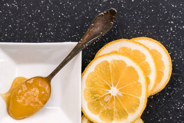 istock Sliced lemon and honey spoon, top view 639253652