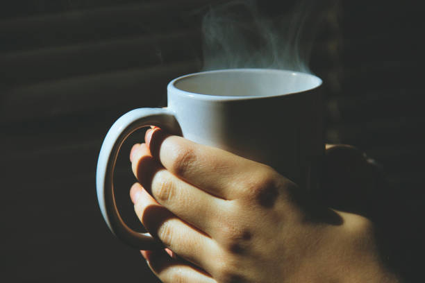 istock hands holding hot cup of tea or coffee 639253842