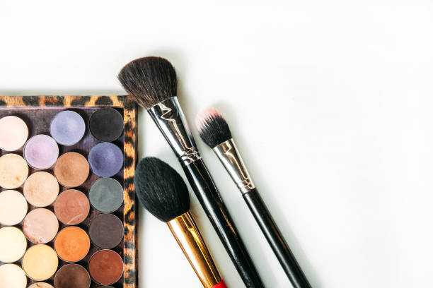 istock Makeup collection brushes and shadows isolated white background 639254196