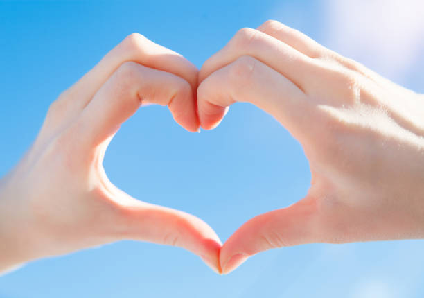 istock Heart shape with hand in sky 639256462