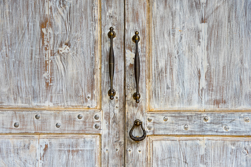 Doorknob and Metal door handle on Vintage white door