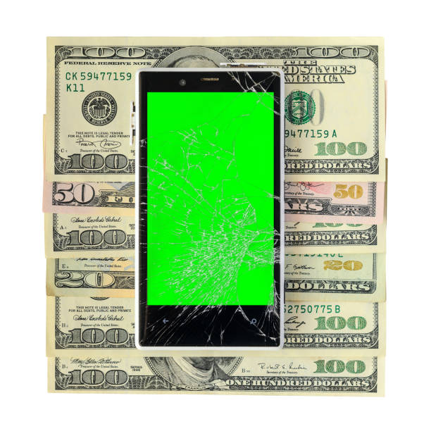 Money banknotes with broken Smartphone Isolated on white White Broken Smartphone on money banknotes isolated on white background with cliping path. Green chroma key display of damaged cellphone white background dollar sign currency symbol dependency stock illustrations