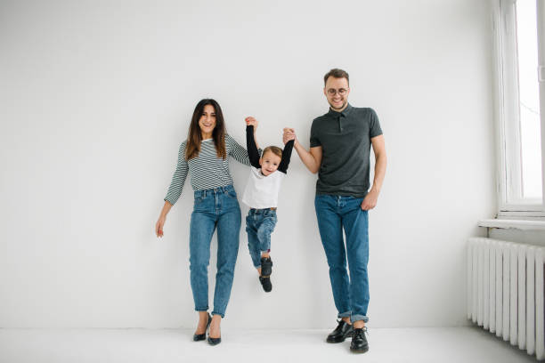 hipster father, mother holding baby boy over white isolated background - cheeper imagens e fotografias de stock