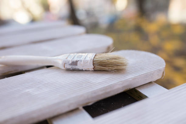 istock Brush with white paint on wooden background 639263660