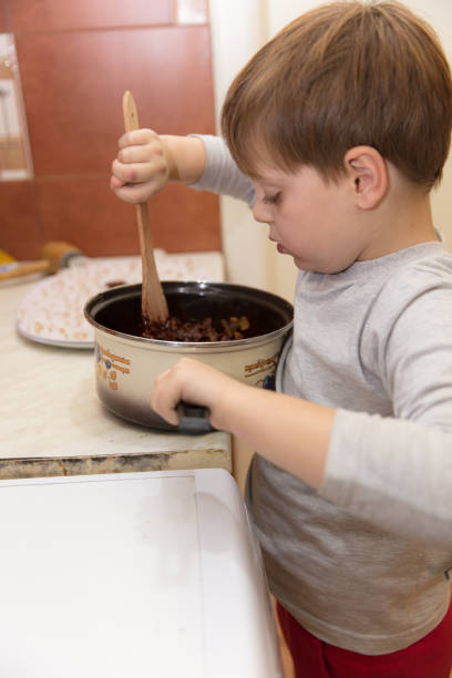 istock Little boy making cookies 639263820