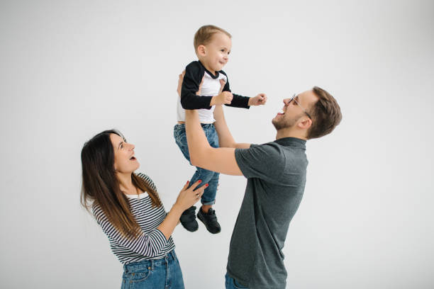 hipster father, mother holding baby boy over white isolated background - cheeper imagens e fotografias de stock