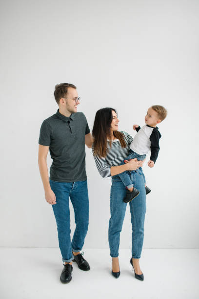 hipster father, mother holding baby boy over white isolated background - cheeper imagens e fotografias de stock