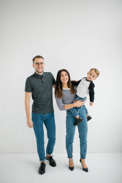 hipster father, mother holding baby boy over white isolated background - cheeper imagens e fotografias de stock
