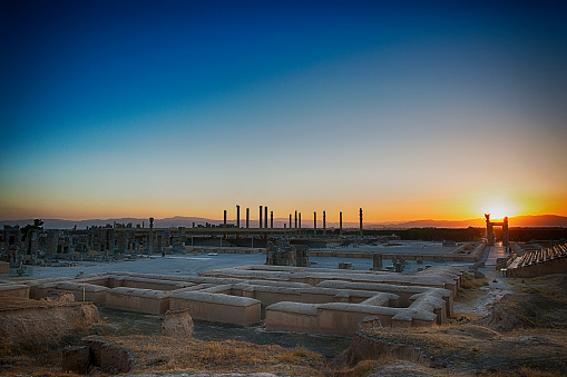 The ruins of the acient city Persepolis at sunset, Iran.  Persepolis (Old Persian: Pārśa; Modern Persian: Pārse) was the ceremonial capital of the Achaemenid Empire (ca. 550–330 BC). The site is situated 60 km northeast of the city of Shiraz in Fars Province, Iran. The earliest remains of Persepolis date back to 515 BC. It exemplifies the Achaemenid style of architecture and is an UNESCO World Heritage Site.