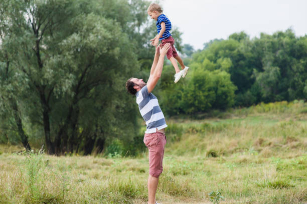 istock Father throwing up his little son 639265174