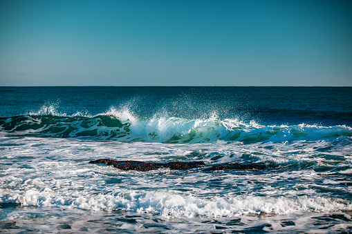 Blue sea with waves and clear blue sky, vintage color