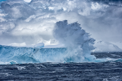 Massive Iceberg floating in the Southern Ocean in Antarctica with stormy seas