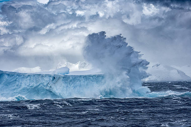 massive iceberg floating in antarctica in a storm - cold frozen sea landscape imagens e fotografias de stock