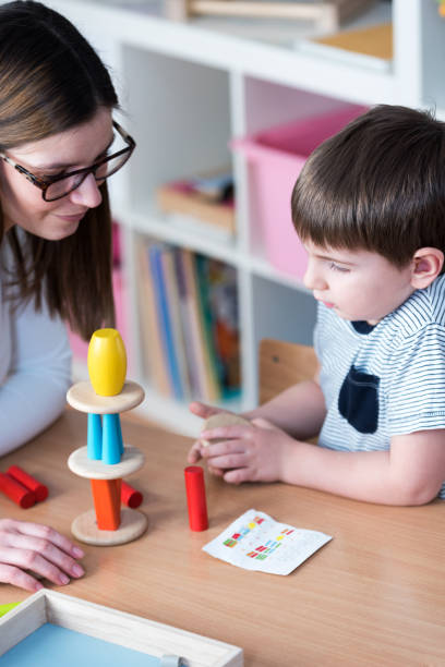 istock Teacher Learning With Cute Preschool Boy 639270800