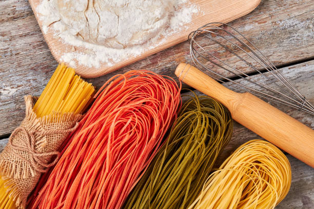 istock Different kinds of spaghetti, dough and cooking utensils. 639271264