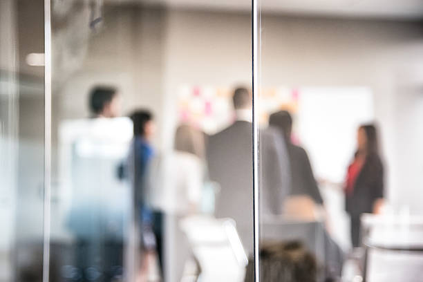 istock Corporate Meeting Behind Glass Wall Blurred Abstract 639279156