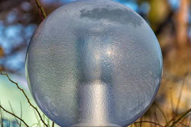 Street lamp glass half frozen in the winter