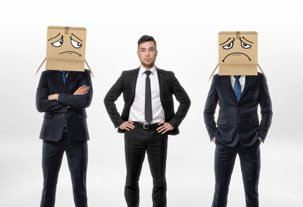 istock One businessman standing between two other men wearing carton boxes 639287888