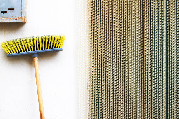 Mediterranean style: A beaded yellow curtain, yellow pushbroom, and rusty mailbox. Shot in Sicily.